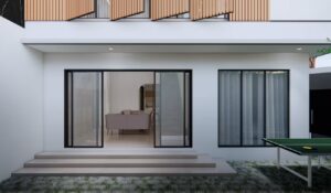 Tampilan belakang rumah Mr. AM dari sisi selatan dengan pintu geser kaca besar yang menghubungkan ruang tamu ke taman belakang.