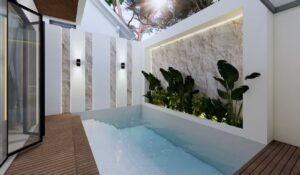 Kolam renang rumah Mr. AM dengan dinding batu alam, tanaman tropis, dan pencahayaan lembut yang menciptakan nuansa resort alami.