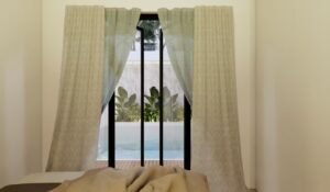 Kamar utama rumah Mr. AM dengan jendela besar menghadap kolam renang pribadi, menciptakan suasana tenang dan mewah.