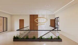 Area transisi lantai dua rumah Mr. AM dengan railing kaca, tanaman hias, dan lampu gantung modern berbentuk spiral berwarna emas yang menjadi fokus visual utama