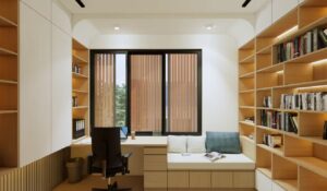 Ruang kerja rumah Mr. AM dengan meja built-in dan rak buku kayu minimalis, pencahayaan alami dari jendela besar, serta seating area yang nyaman untuk membaca.