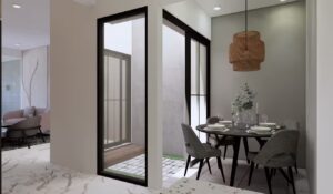 Ruang makan semi-outdoor dengan pintu kaca dan lampu anyaman dekoratif.